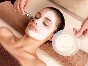 Cosmetologist applies a rejuvenating mask
