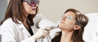 Beautician holds laser rejuvenation procedure